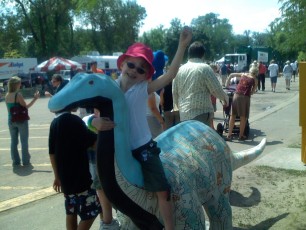 Mykala sitting on a painted dinosaur