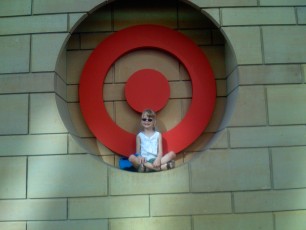Mykala sitting in the Target sign