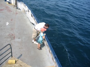 Mykala and Daddy standing by the rail on the Madeline Island Ferry