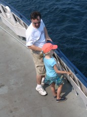 Mykala and Daddy standing by the rail on the Madeline Island Ferry