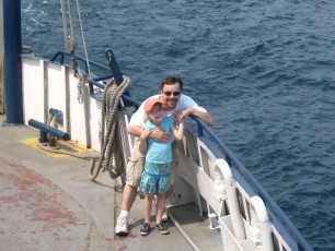 Mykala and Daddy standing by the rail on the Madeline Island Ferry