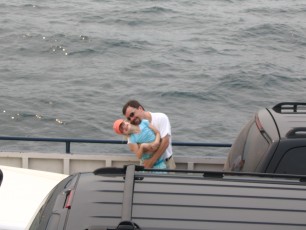 Mykala and Daddy standing by the rail on the Madeline Island Ferry