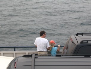 Mykala and Daddy standing by the rail on the Madeline Island Ferry