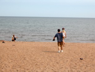 Mykala and Daddy walking on the beach