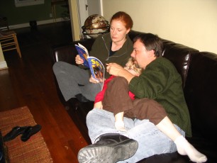 Mykala, Daddy and Corinne reading about space