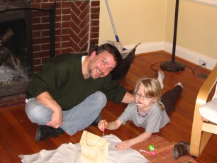 Daddy and Mykala painting a bird house