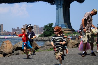 Some kids running through the park