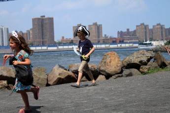 Some kids running through the park